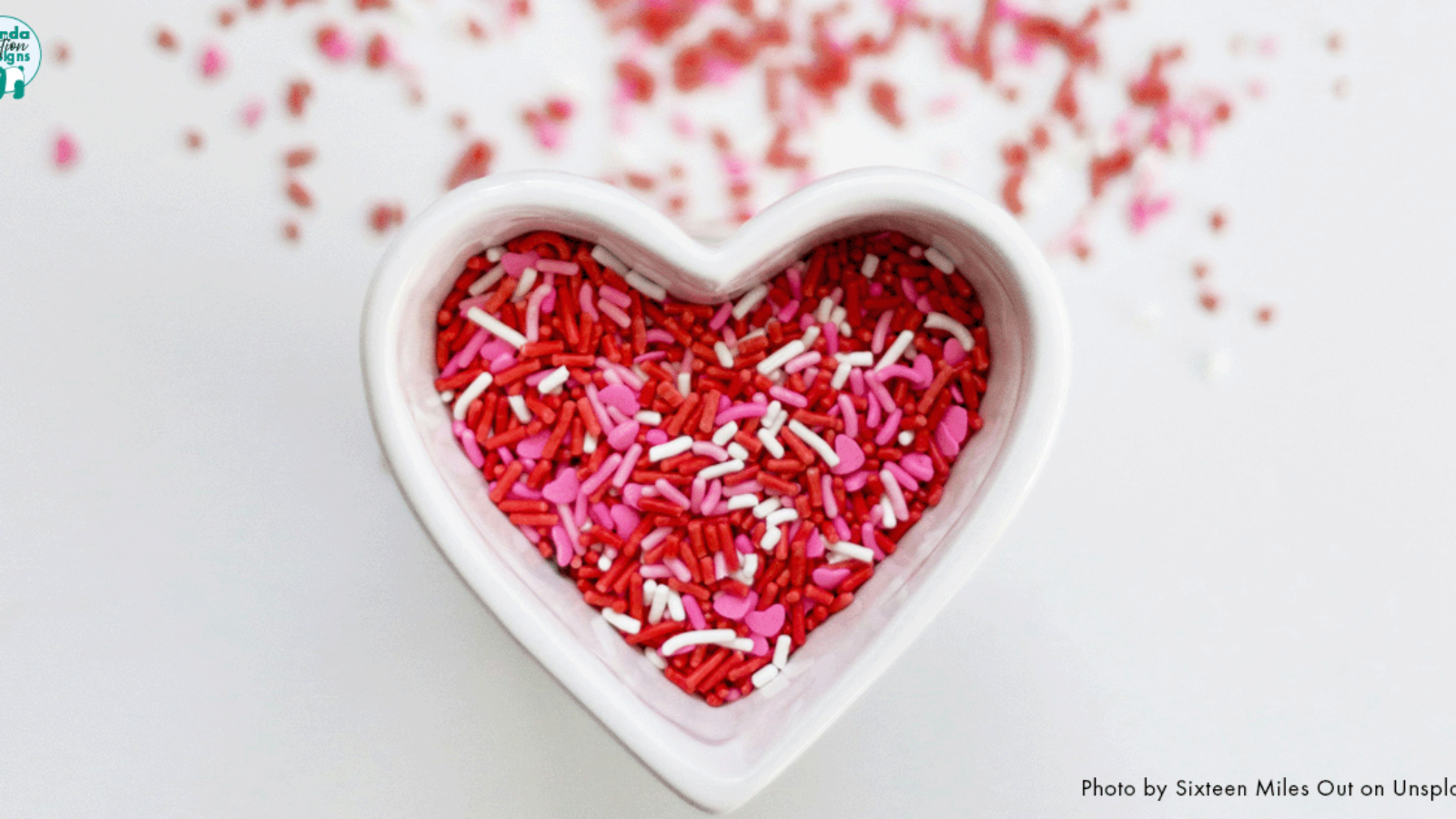 Heart shaped bowl filled with red, pink and white sprinkles