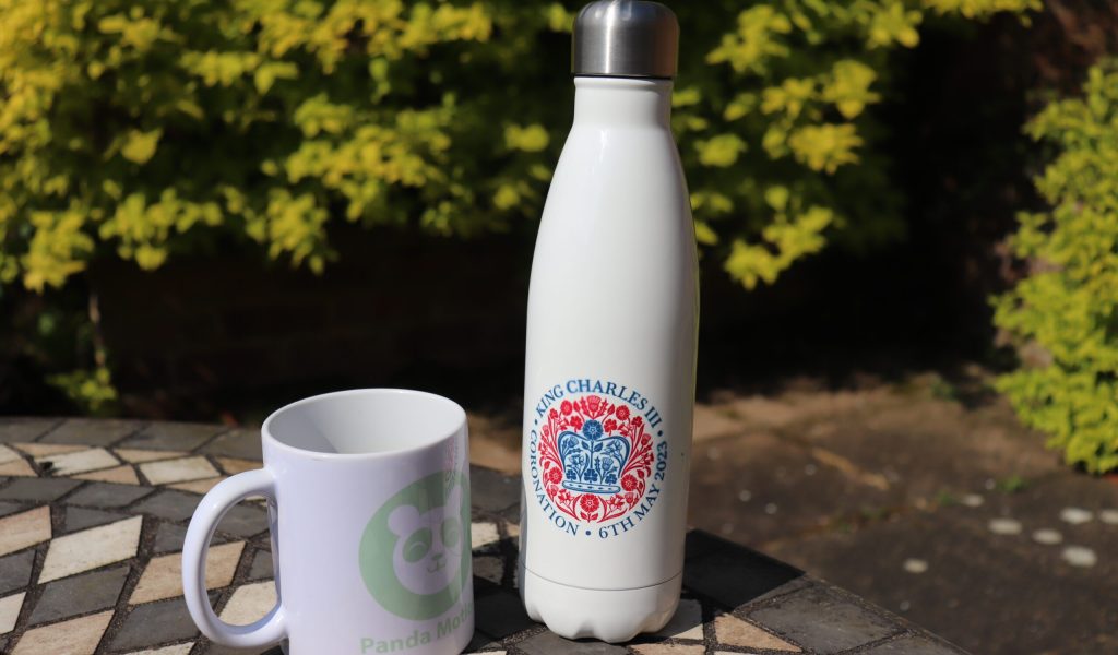 Coronation Water Bottle beside mug
